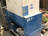 a blue and white machine in a warehouse with other equipment