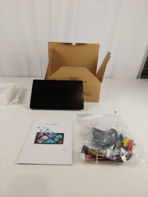 a laptop computer sitting on a table next to a box