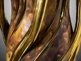 a gold vase that is sitting on a table