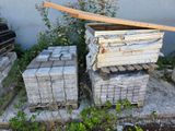 a pile of bricks sitting on the ground next to a pile of crates