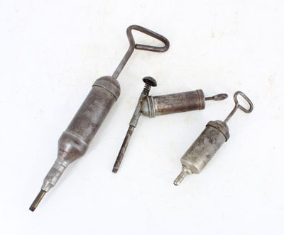 three different types of tools sitting on top of a white surface