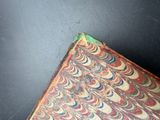 an old book that is sitting on a table