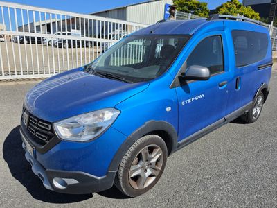 a picture of a blue van parked in a parking lot