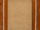 an old wooden frame with a picture hanging on the wall