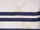 a close up of a white and blue striped shirt with a gold eagle on it