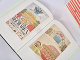 an open book on a table with pictures of people on it