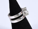 sterling silver ring with square cut stones on top of a black cone