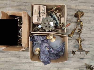 a box of assorted items sitting on a wooden floor