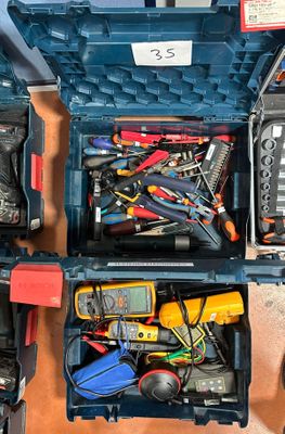 many different tools in a blue case on the floor
