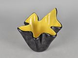 black and yellow ceramic bowl with two fish in the center
