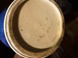 a person holding a bowl of soup in their hand