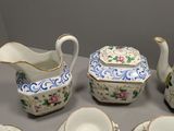 a table with a variety of china items on it