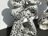 two black and white vases sitting on a table