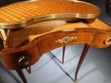 a wooden desk with a checkered top on it