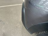 a black car parked in a parking lot next to a parking meter