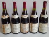 six bottles of wine are lined up in a row on a table
