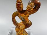 a close up of a sculpture of a person holding a bird