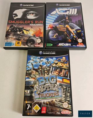 three video games are sitting on a table with a white background