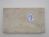 a small piece of paper with a sticker on it
