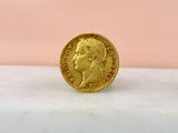 a gold coin sitting on top of a marble counter