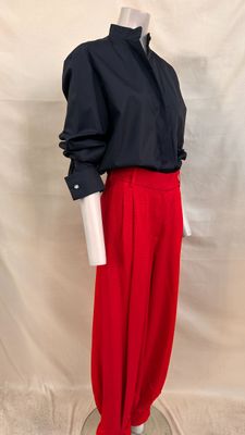 black and red shirt and red pants on a mannequin base