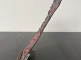a knife that is sitting on top of a wooden stand