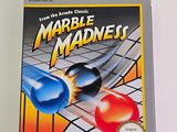 a box of marbles on the table next to the game