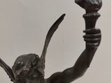 bronze statue of a woman holding a bird in her hand