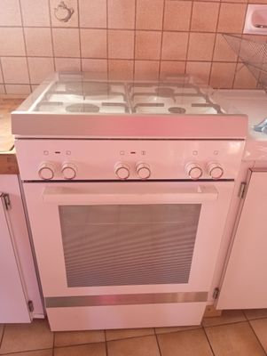 a white stove top oven sitting in the middle of a kitchen
