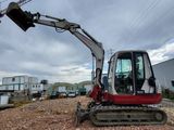 a small excavator that is sitting in the dirt