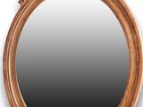 an oval mirror with a bird and flower decoration on it
