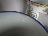 two cups and a bowl sitting on a table