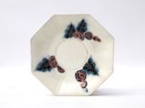 a white plate with a blue and red design on it