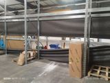 a picture of a warehouse with a lot of boxes and pallets