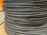 an image of a stack of black wires on a wooden table