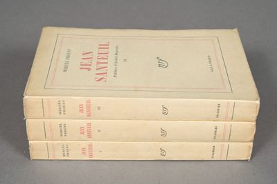 three books are stacked on top of each other on a table