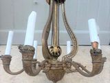 a chandelier that has five candles on it