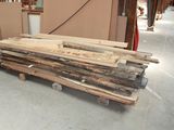 several pieces of wood are stacked on pallets in a warehouse