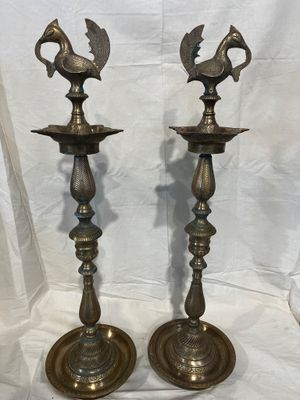 pair of antique brass candlesticks with birds on them