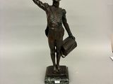 statue en bronze représentant une femme tenant un chapeau et une canne