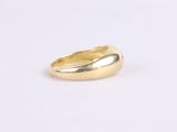 a close up of a gold ring on a white surface