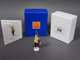 a figurine of a soldier with a drum and a box of cards