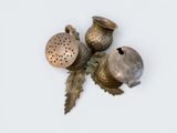 three metal objects that are sitting on a white surface