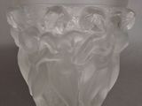 a glass vase with a design on it on a table
