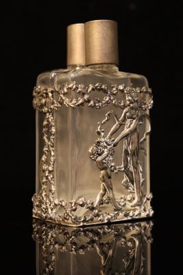 an image of a bottle of perfume on a black surface
