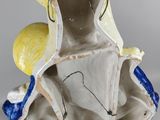 an image of a figurine of a woman with a bird on her head