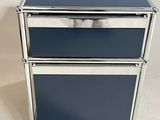 two blue metal drawers on wheels on a white surface