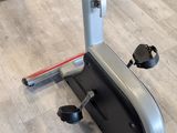 a row of stationary exercise bikes in a gym