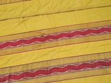 a close up of a yellow and red striped blanket