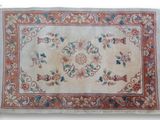 an antique rug with a floral design and fringes on a white background